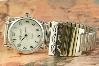 Beautiful Sterling Silver Watch Tips with Gold Fil contemporary design. Mens quartz watch with expandable band. Created by Navajo Artist Tommy Singer. Signed.